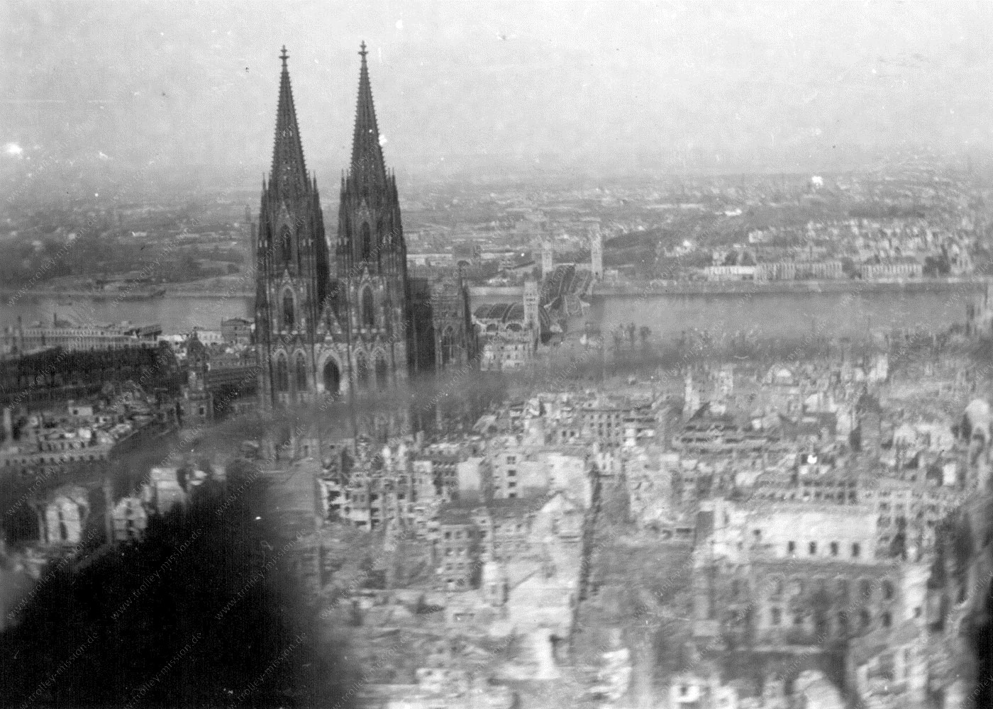 Tiefflug über das durch Fliegerbomben zerstörte Köln und den Kölner Dom - Luftaufnahme aus dem Mai 1945 erstellt aus der Flugzeugnase