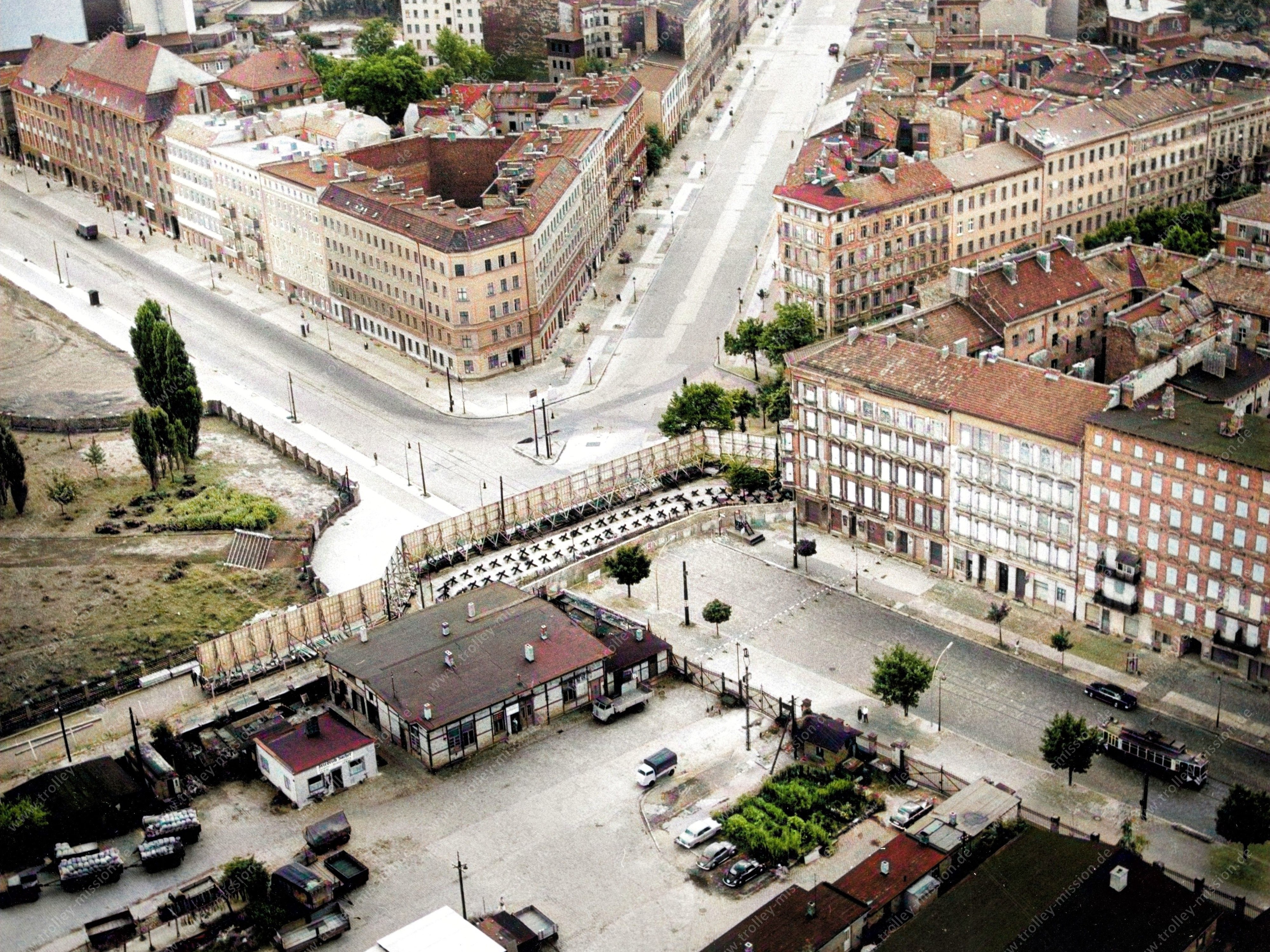 Das Luftbild zeigt in der unteren, rechten Bildhälfte die Bernauer Straße noch mit den alten Wohnhäusern und sogar mit Straßenbahn.